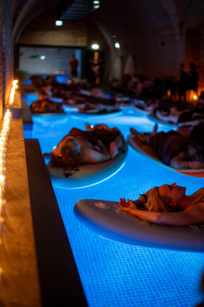 Water concert participants floating on SUP boards in the pool