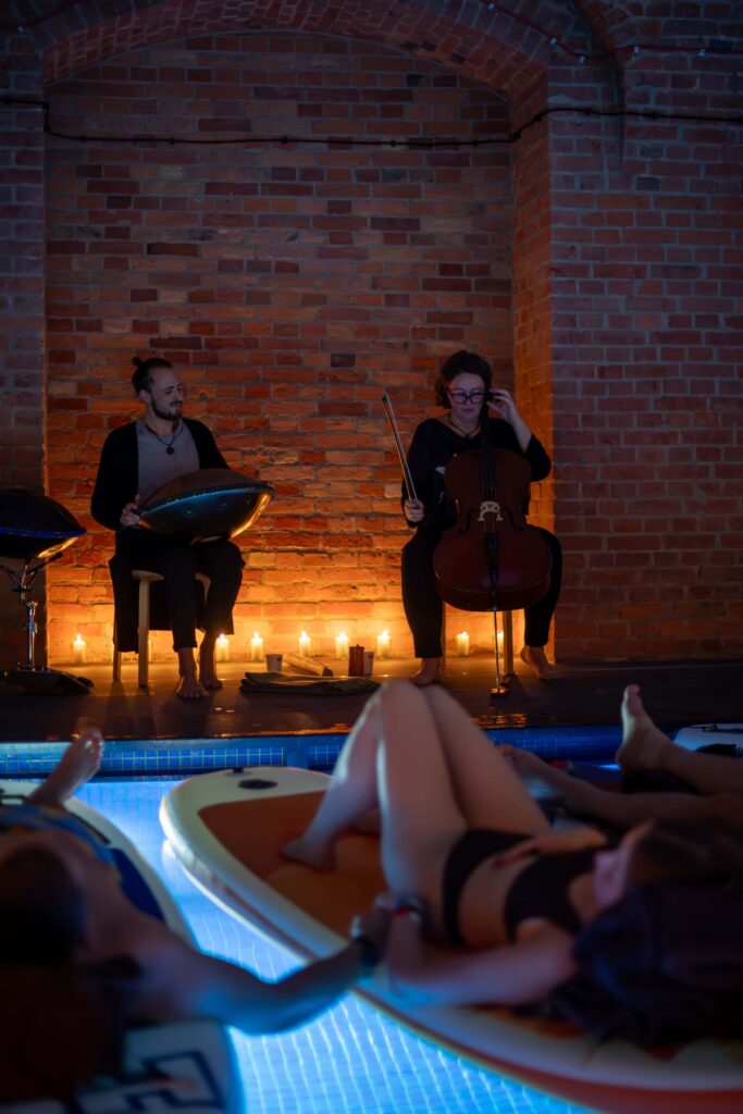 Musicians playing instruments above the pool